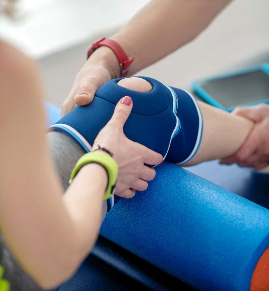 Pre & Post-Operative Rehabilitation 1 male physiotherapist hands holding knee bandage of 2024 10 11 19 04 08 utc