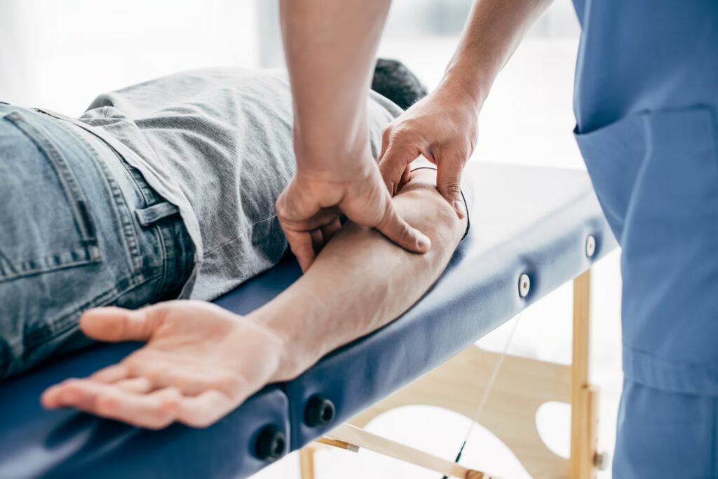 partial view of chiropractor massaging arm of pati 2024 11 18 15 54 32 utc